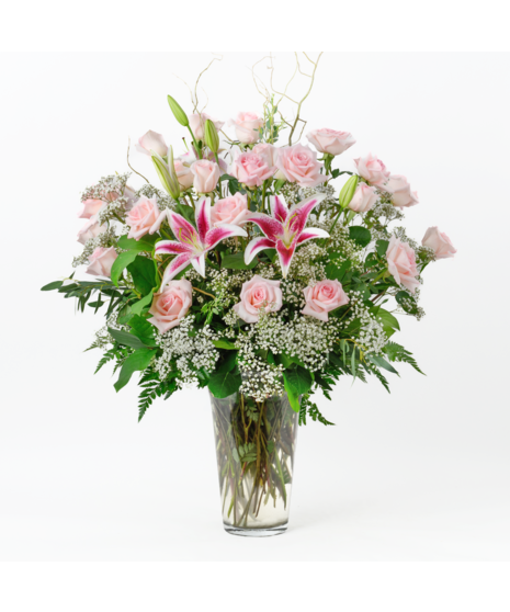 Valentine's Day Twenty Four Pink Roses and baby's breath flowers in a clear glass vase by Freytag's Florist