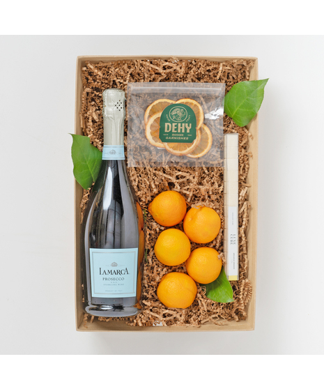 includes a bottle of  Lamarac Prosecco, Dehy Orange Garnishes, Arcadia Orange Luxe Mixology sugar cube, and juice oranges sorted in a perfect-sized wooden crate 