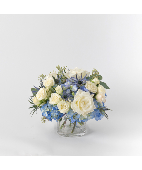 The Light of Spirit arrangement brings a serene elegance to your Hanukkah celebrations. 