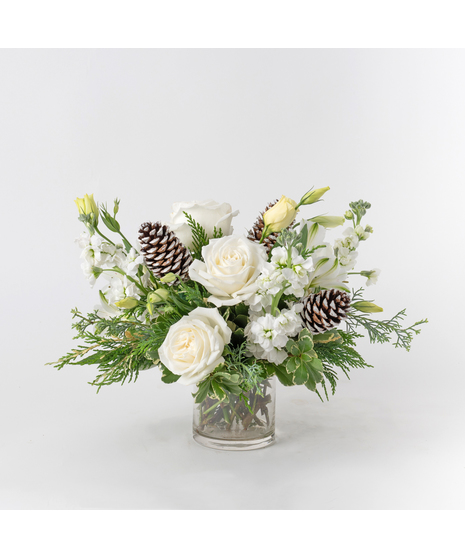 Delicate and enchanting, the Snowflake Kisses arrangement captures the serene beauty of winter in a charming 4-inch glass vase.