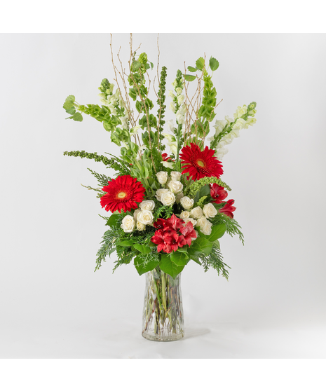 Celebrate the magic of the holidays with our stunning 'Tis the Season arrangement, a tall and elegant display of festive beauty. 