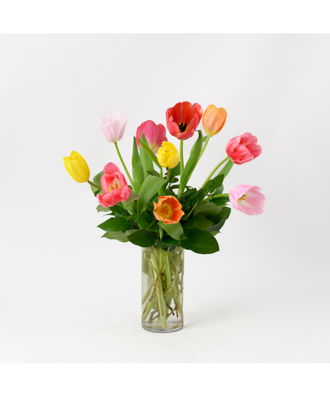 Ten Spring Tulips bouquet is multiple colors in a glass vase